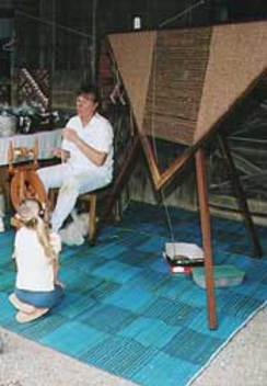 Dianne Demonstrating Spinning & Weaving on a Trangle Loom During an Open House