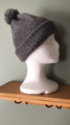 Hand-knit hat with pom-pom