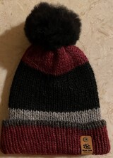 hat with pom pom and label