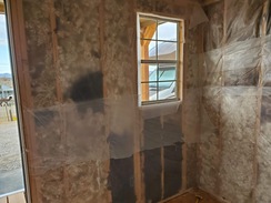 Fiber Insulation and visqueen on store walls