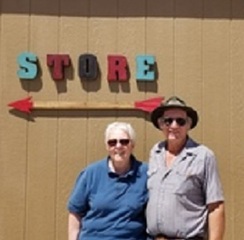 Glenn and Carolyn in front of the store.